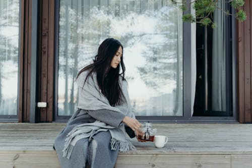 Free Woman Pouring Tea in a Cup Stock Photo