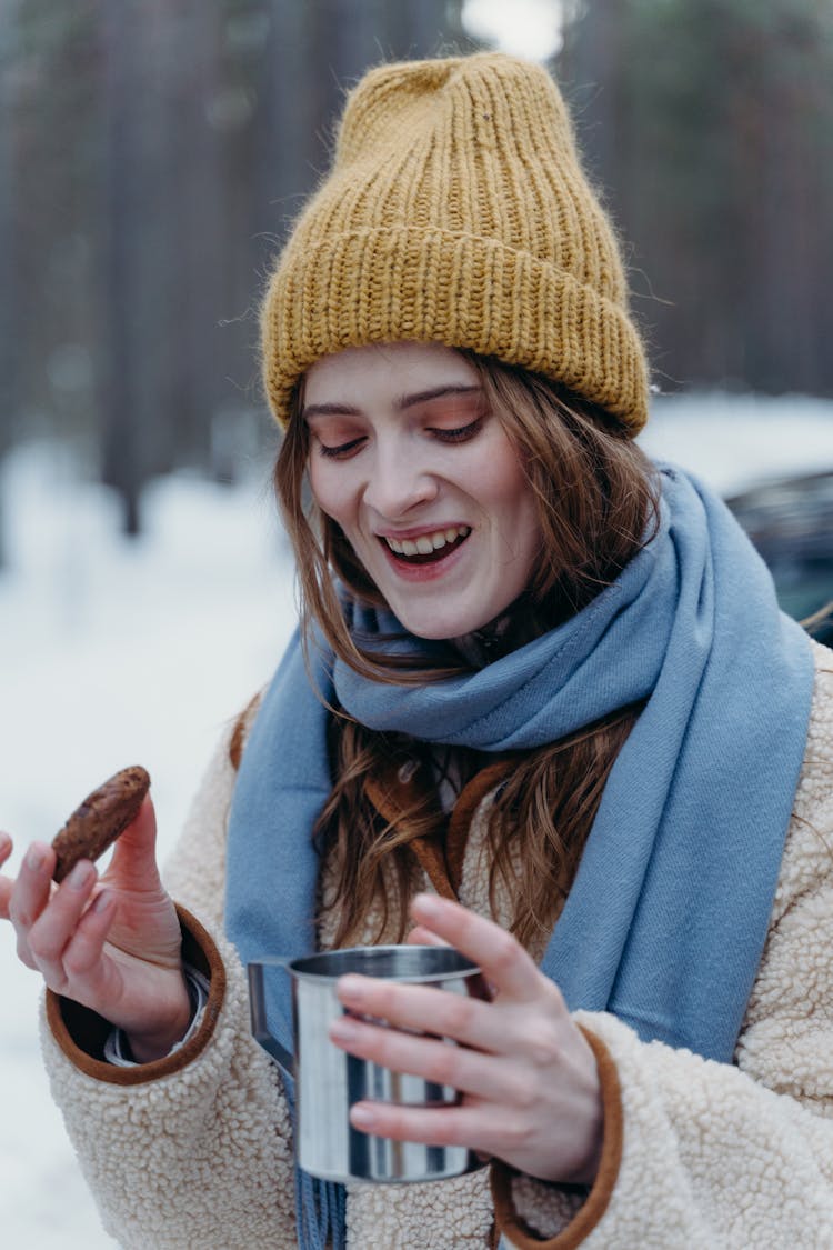 Woman Holding A Cup And A Cookie