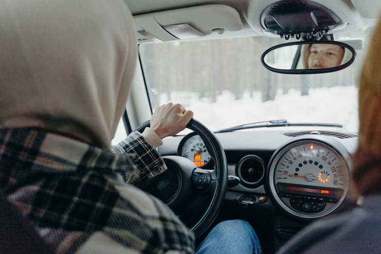 Person In Blue Denim Jeans Driving Car