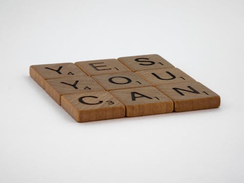 Close-Up Photo of Yes You Can Text on White Surface