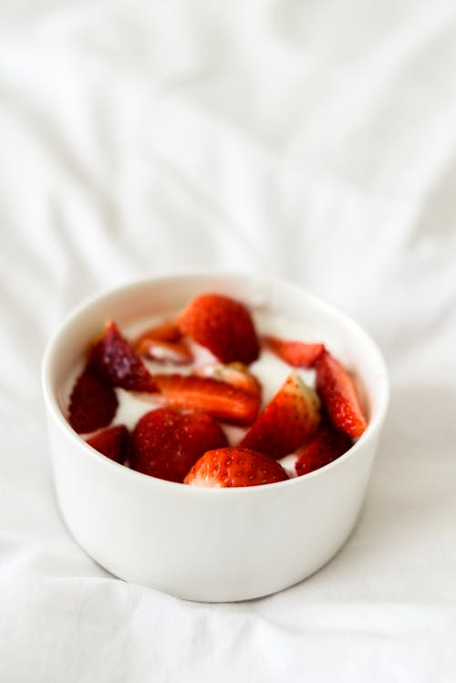Slices of Strawberries in White Bowl
