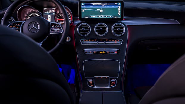 Sleek and modern interior of a Mercedes-Benz with illuminated dashboard and steering wheel.