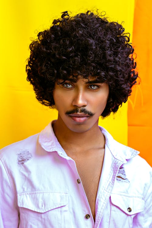 Stylish black model with Afro hairstyle and mustache · Free Stock Photo