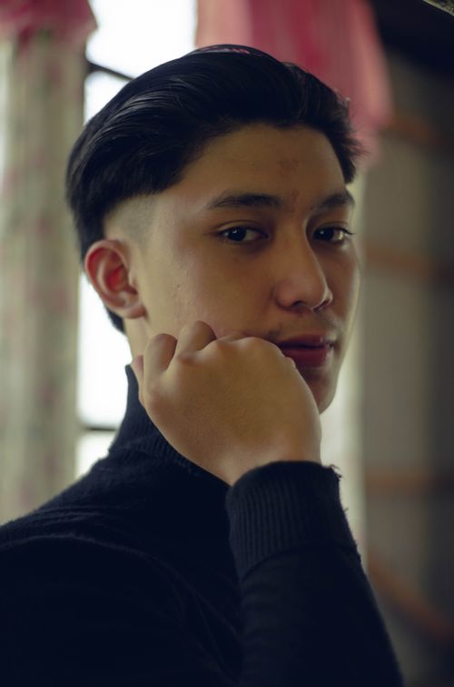 Free Captivating portrait of a young man posing indoors in Majayjay, Philippines. Stock Photo
