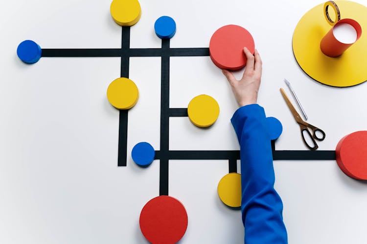 Person Touching Colorful Circles Connected With Black Lines On White Background 