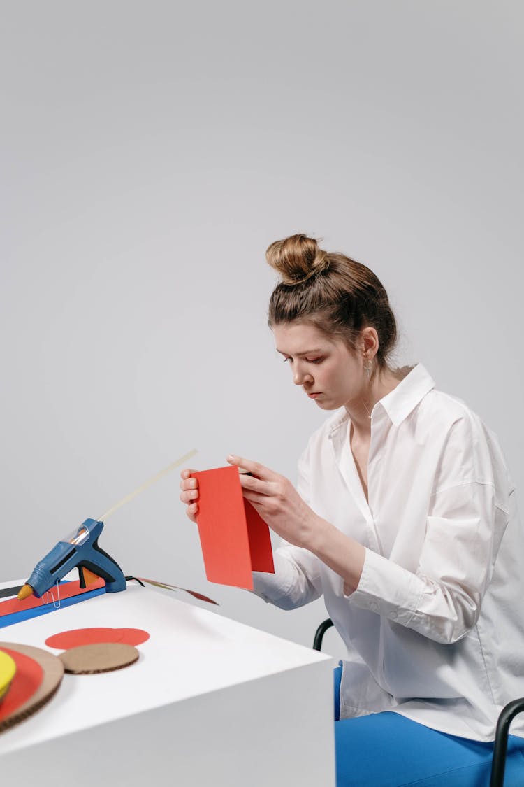 A Woman Folding Red Paper