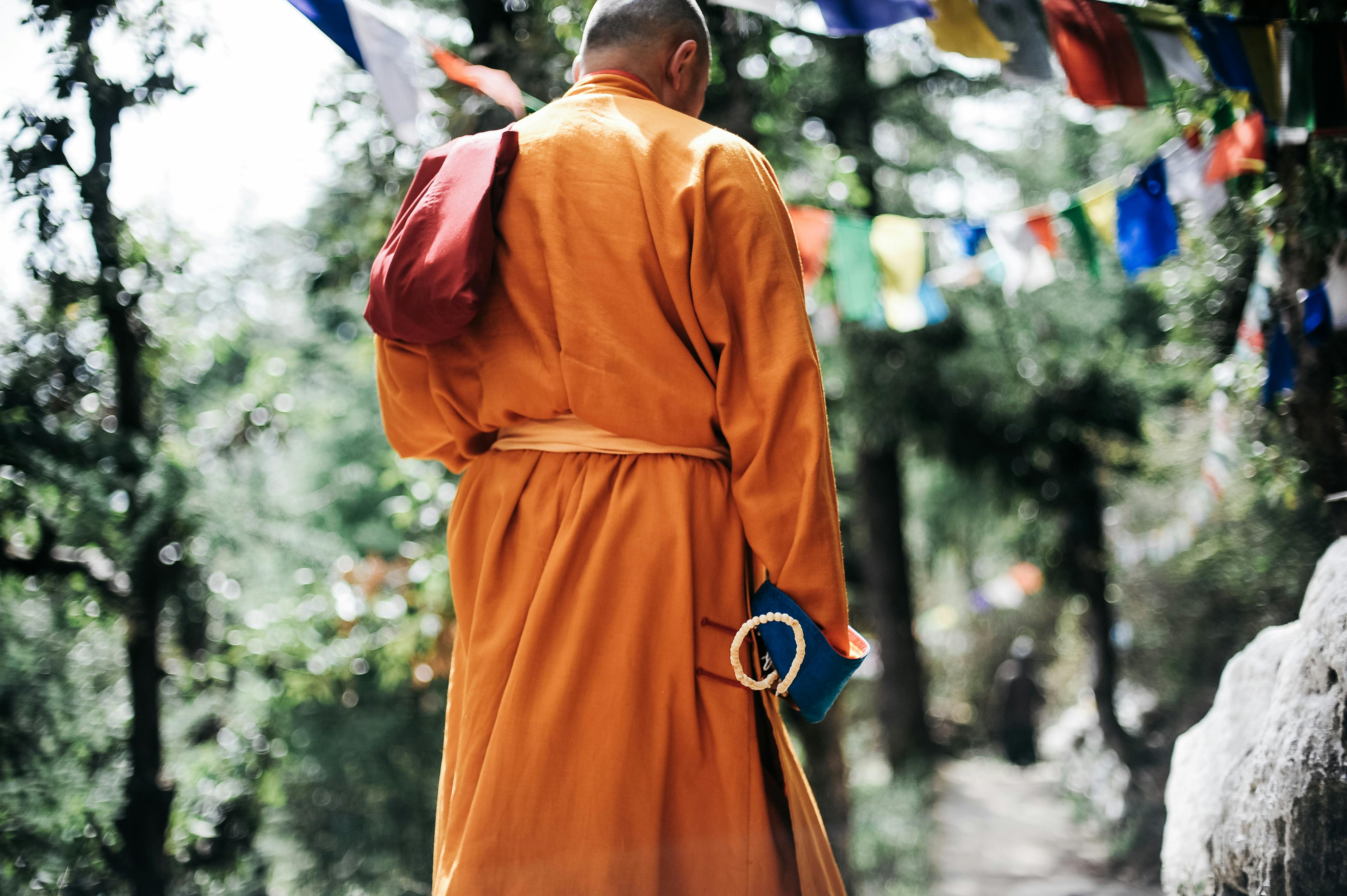 Monks Holding Jars Near Green Leafed Trees · Free Stock Photo