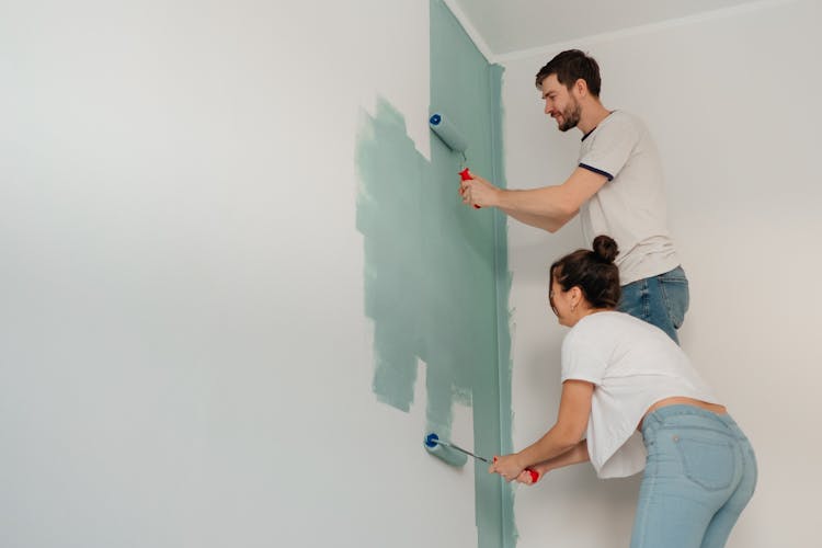 Couple Painting A Wall