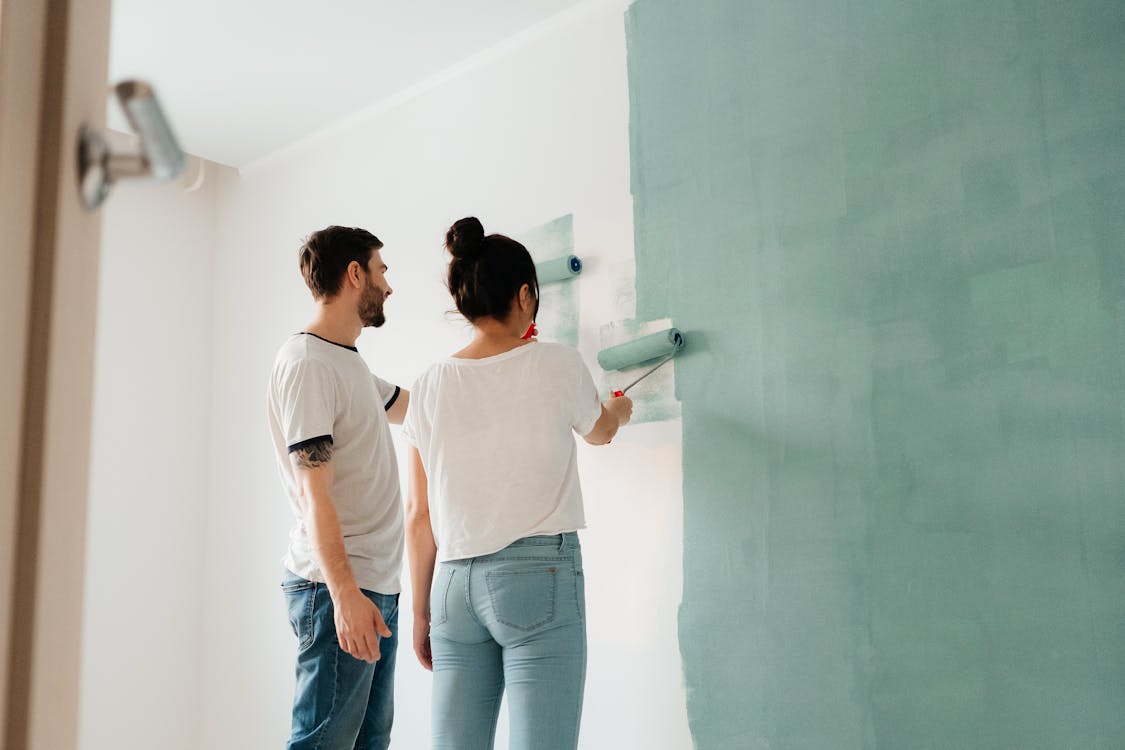 Free A Couple Painting the Wall Stock Photo