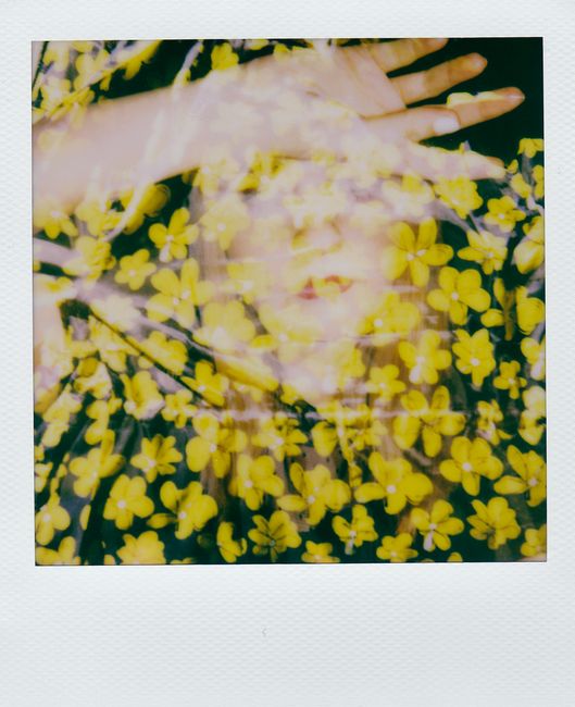 A captivating double exposure of a woman with yellow floral elements, creating an artistic effect.