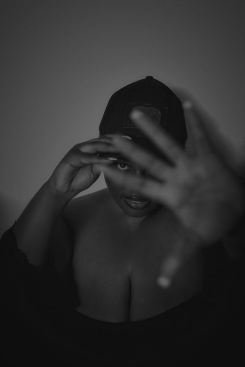 Free Striking grayscale portrait of a woman covering her face, with focus on expression. Stock Photo