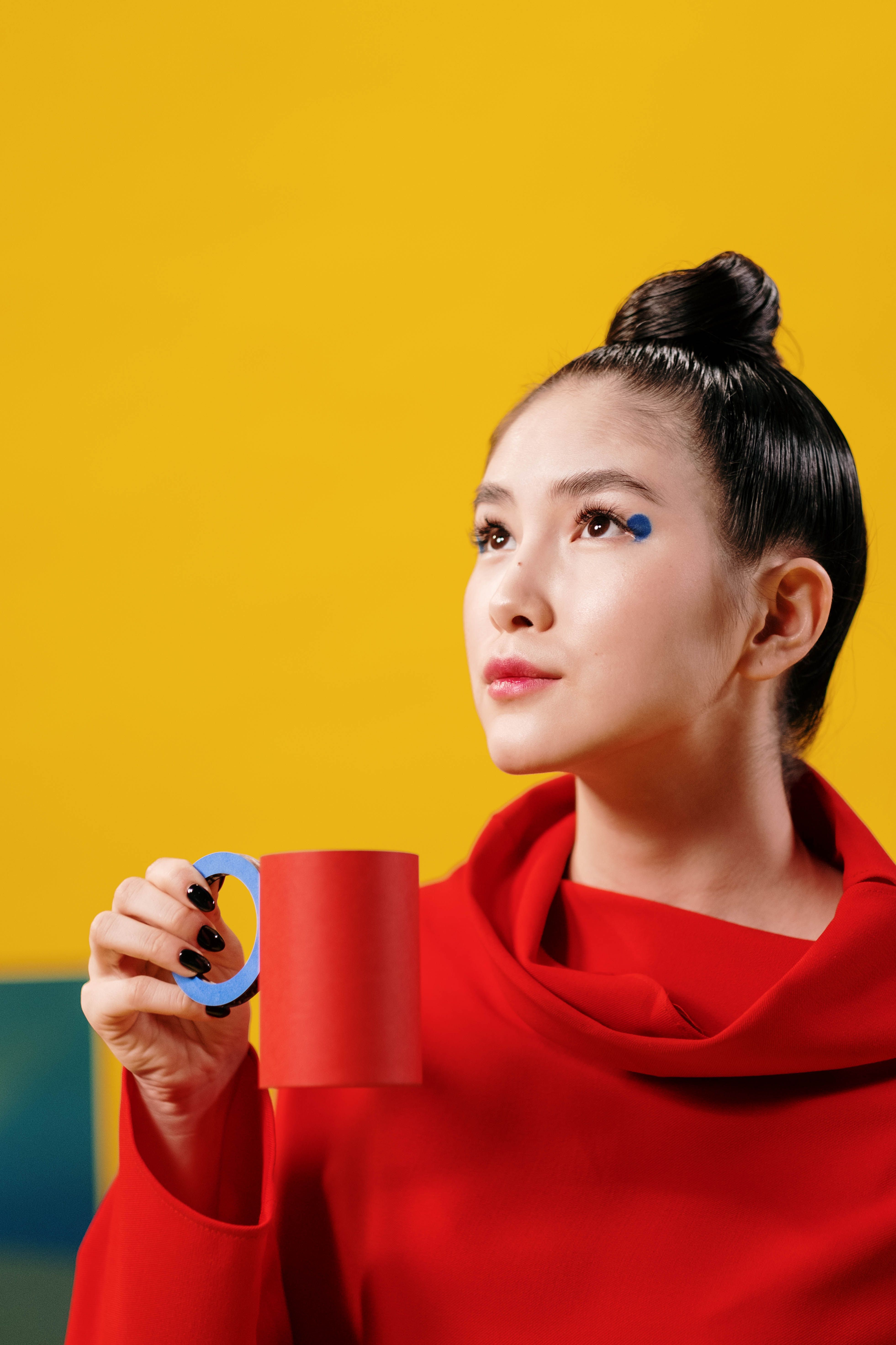 A Woman In Red Dress Holding a Paper Cup · Free Stock Photo