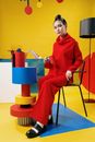 Girl in Red Long Sleeve Dress Sitting on Orange and Blue Plastic Chair