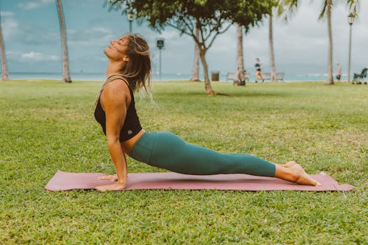 Woman practicing yoga outdoors, showcasing flexibility and healthy lifestyle.