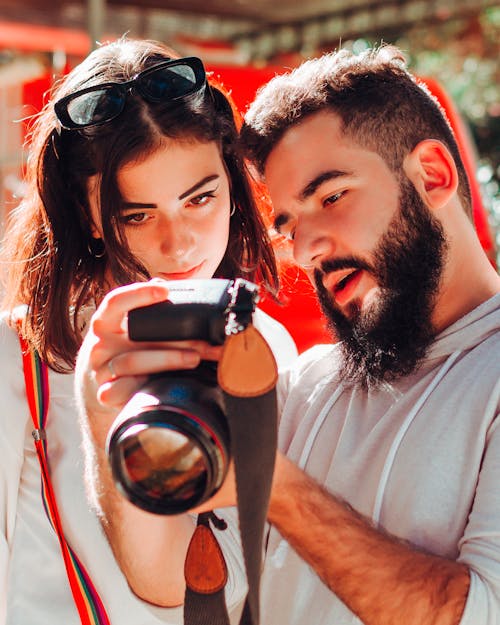 Male photographer showing pictures to female client