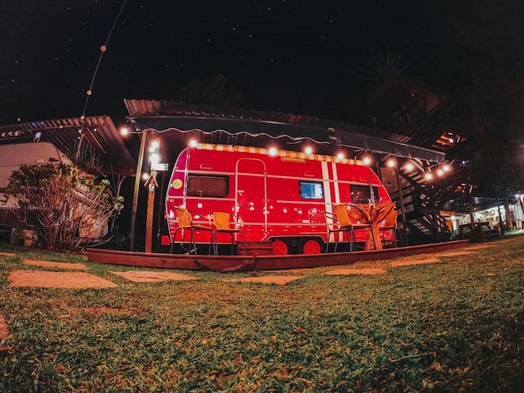 Red Caravan Parked In Campsite At Night