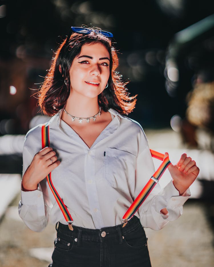 Content Young Ethnic Lady Wearing Pride Rainbow Suspenders On Street