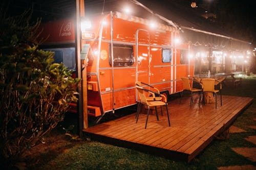 Orange trailer with streetlights and table