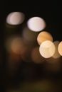 Blurred abstract bokeh backdrop of overlapped white and beige lights spreading in air at dusk
