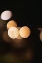 Abstract bokeh background of transparent round shaped beige lights diffusing in air at dusk