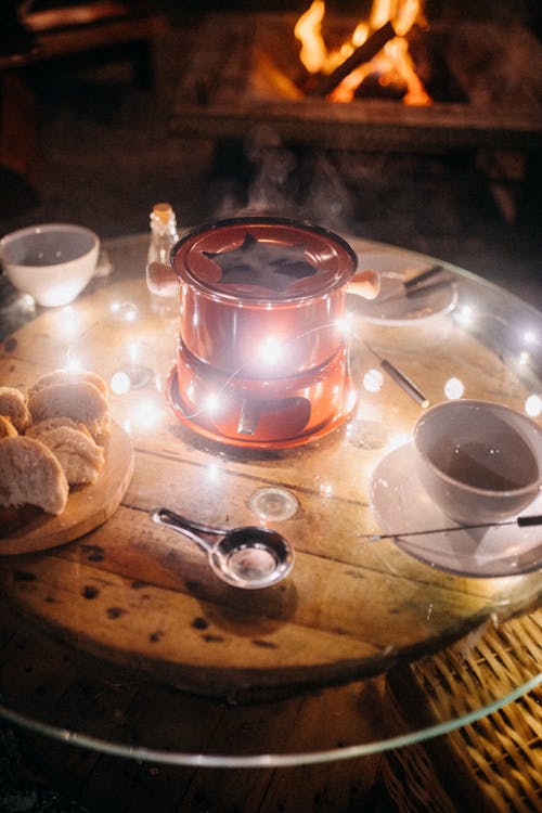 Hot fondue with cups on garden table