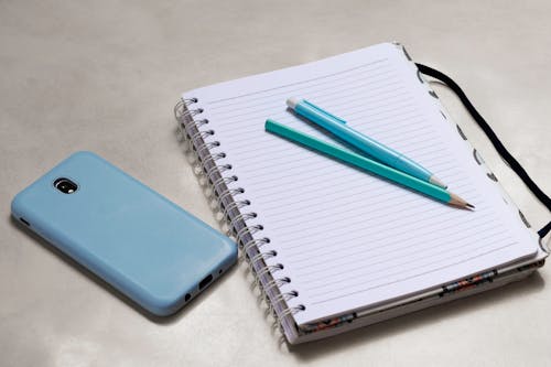 Free Blue Click Pen on White Notebook Stock Photo