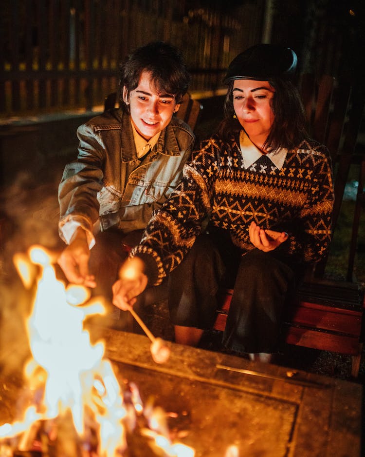 Friends Roasting Marshmallow On Campfire