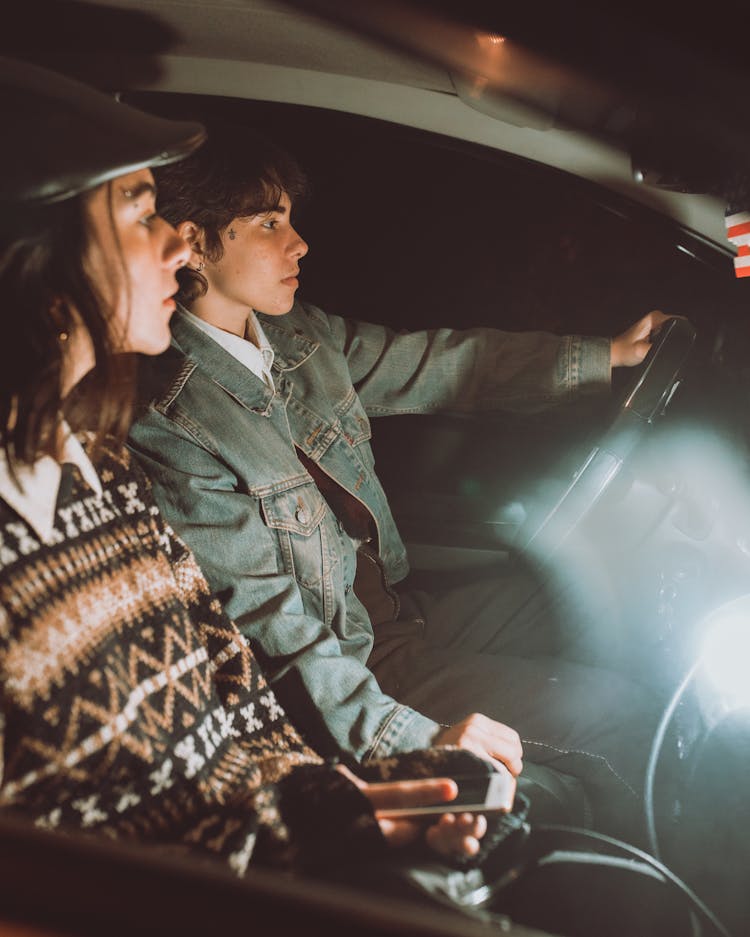 Crop Girlfriends With Smartphone Driving Transport In Evening