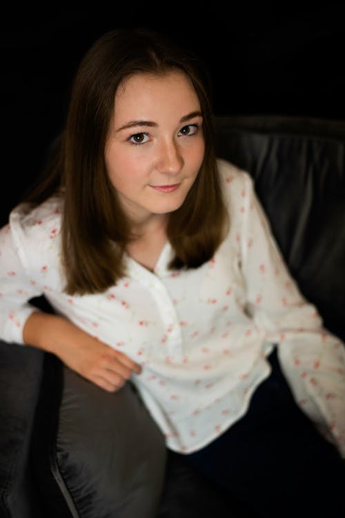 Free A Woman Sitting on the Couch Stock Photo