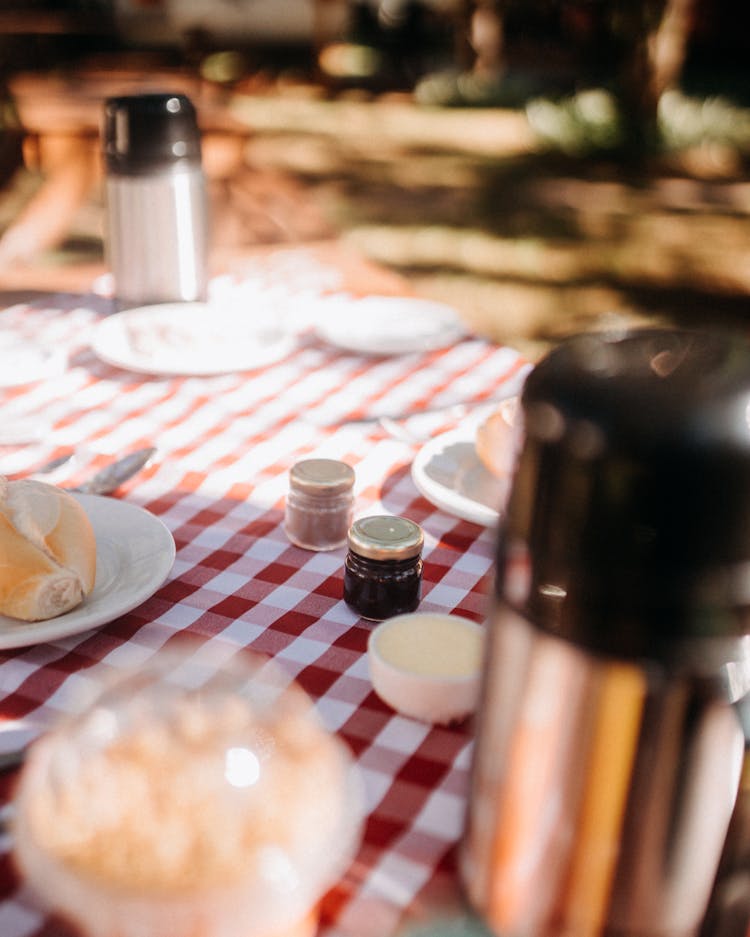 Picnic Table With Thermoses And Jam