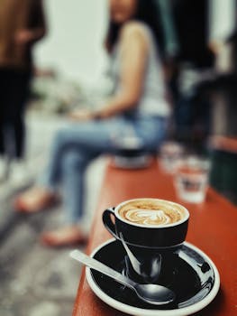 A beautiful latte with intricate art design in an outdoor café in Tambon Si Phum, Chiang Mai, Thailand.
