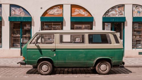 Free Retro green van parked in front of a shop on a sunny day in Prague, Czech Republic. Stock Photo