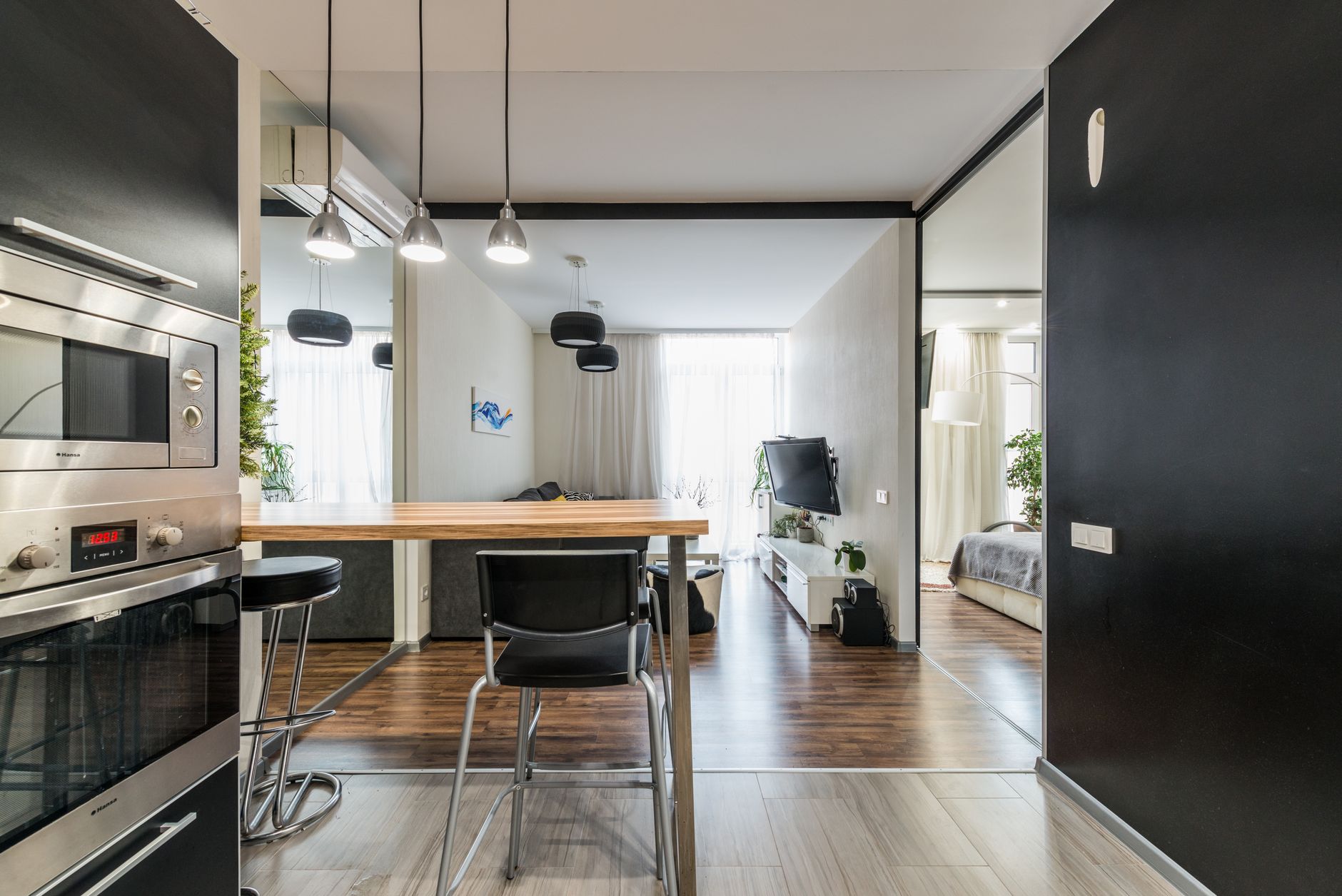 Stylish modern apartment with open plan layout, featuring kitchen, dining, and living areas.