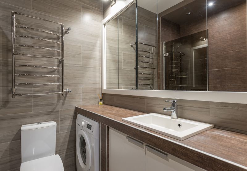 Tiled bathroom with large mirror and vanity