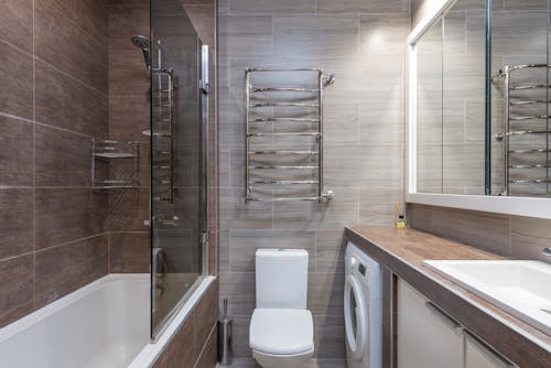 Contemporary bathroom interior with bathtub and toilet bowl