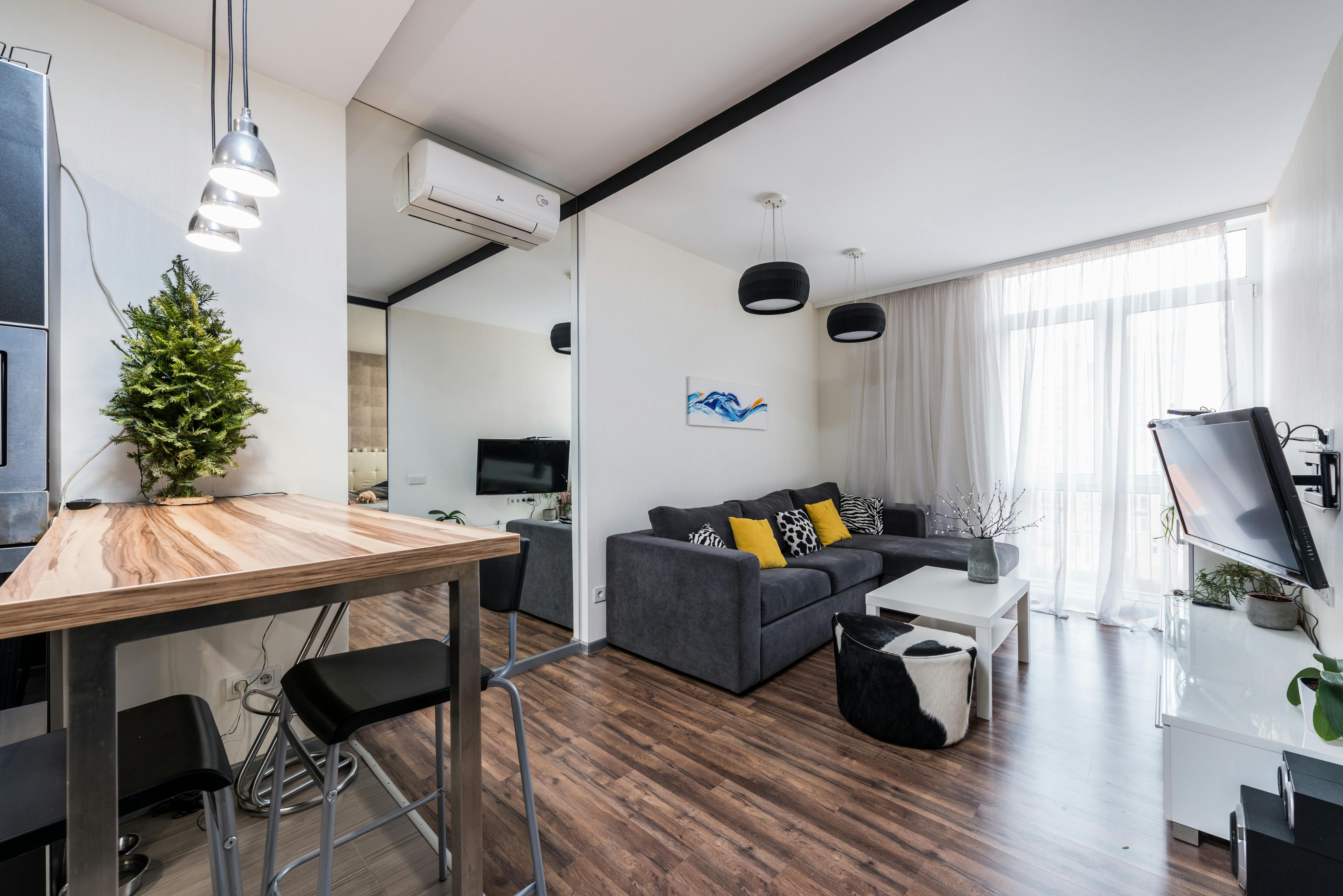 spacious living room with cozy sofa and wooden counter