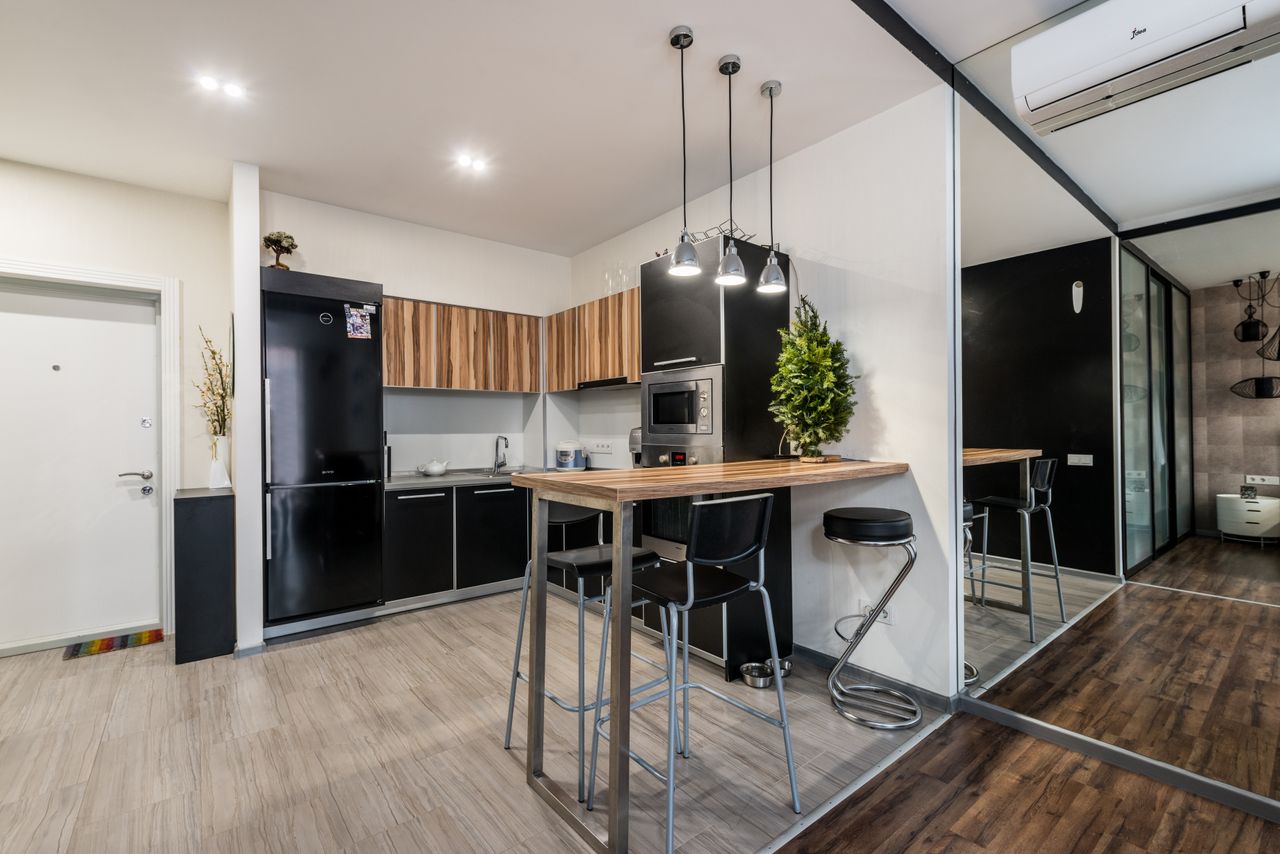 An undercounter fridge built into bar cabinetry
