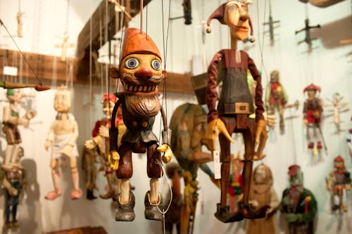 Free Hanging Wooden Marionettes Stock Photo