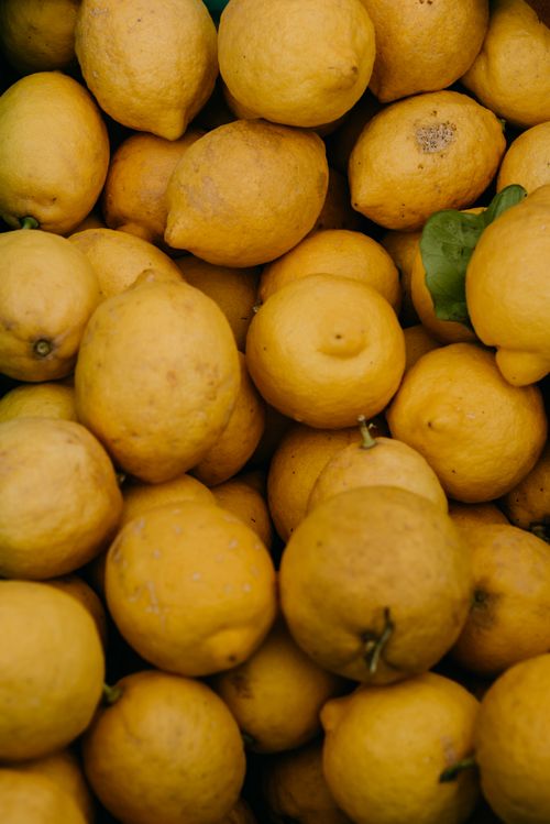 Free A vibrant display of fresh lemons in a close-up, showcasing their vivid yellow color and natural texture. Stock Photo