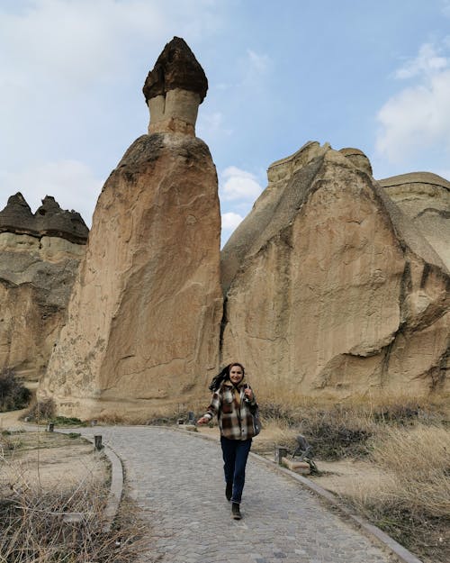 Woman Hiking among Volcanic Rocks in Cappadocia