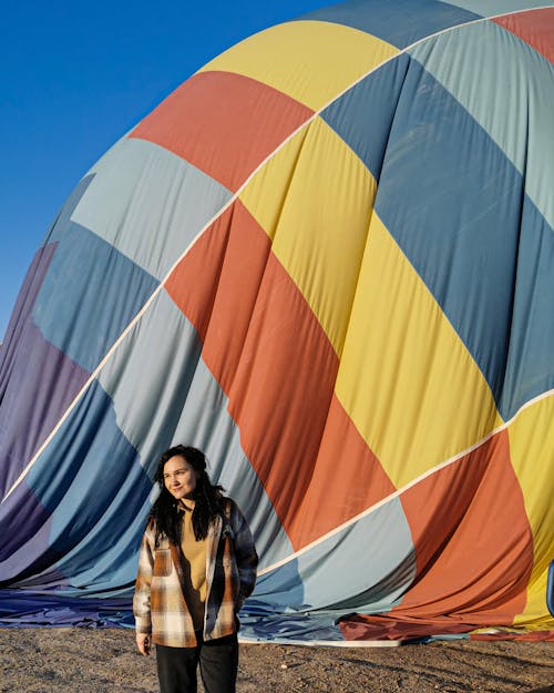 Woman with a Hot Air Balloon Getting Filled Behind her 