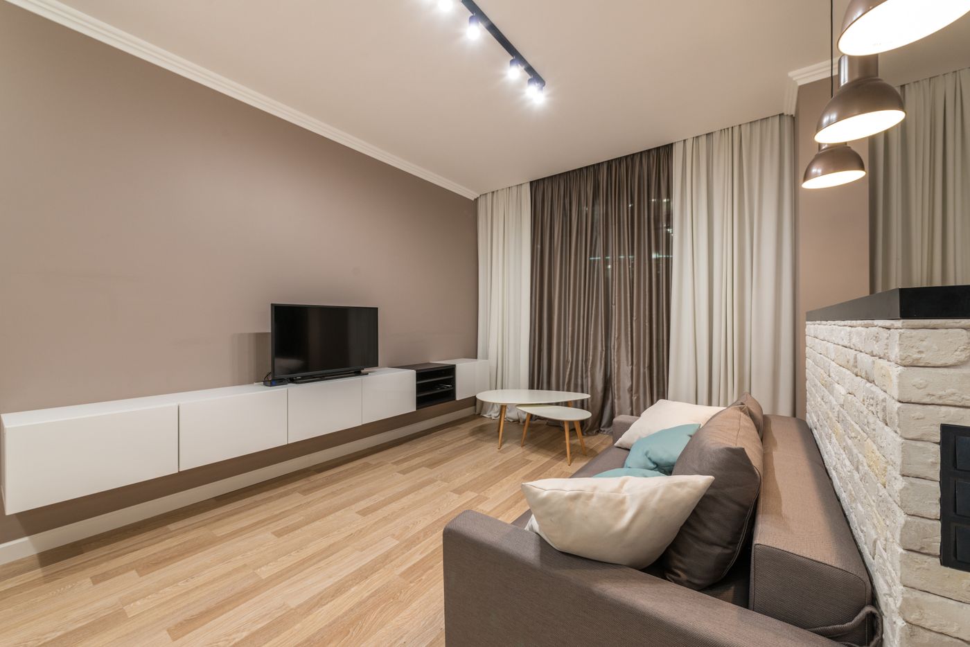 Modern spacious living room with TV and sofa