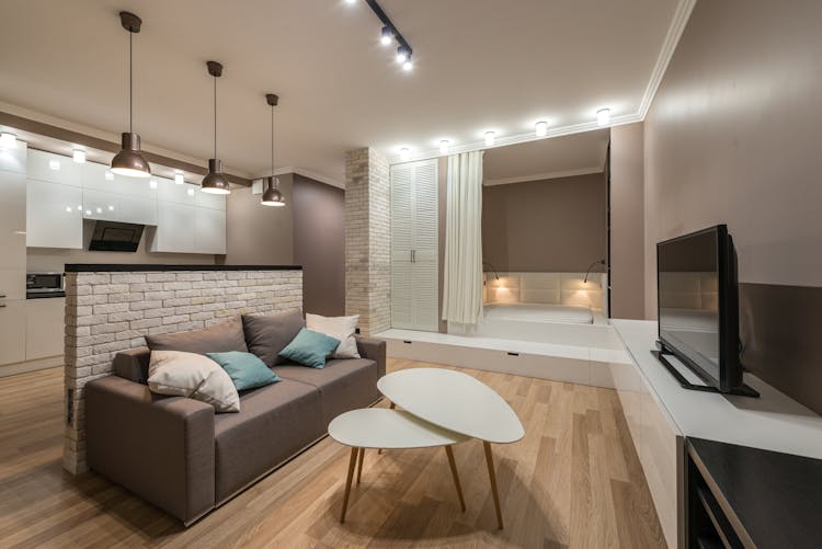 Spacious Living Room With Couch And Coffee Table And TV