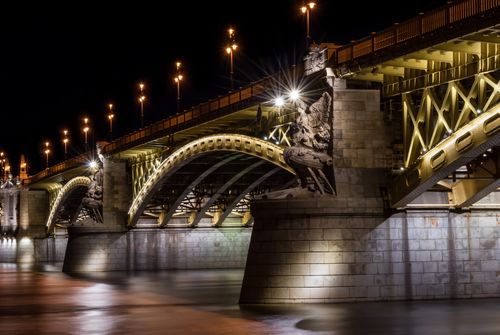 Free Night view of the illuminated Margit Bridge in Budapest, showcasing its architectural beauty over the Danube River. Stock Photo