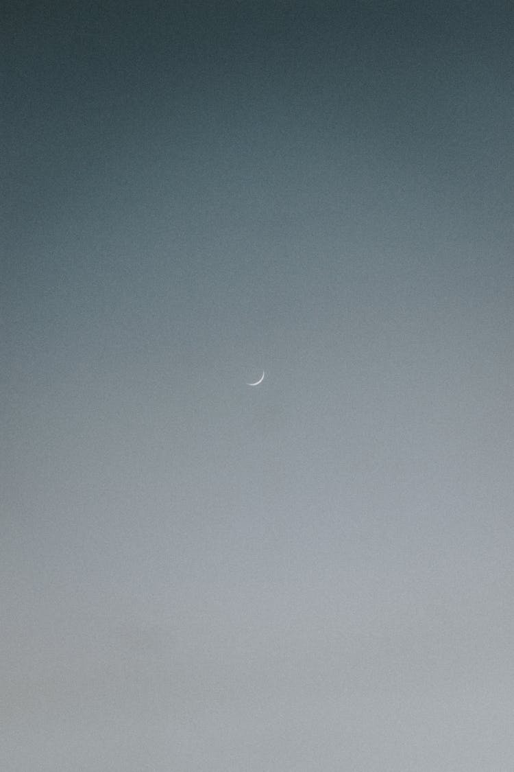 Crescent Moon In Light Sky In Evening