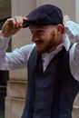 Man Wearing a Hat and Vest