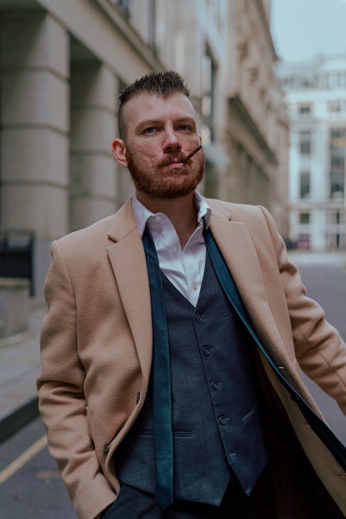 Free Man in Brown Suit Jacket Standing Near Building Stock Photo