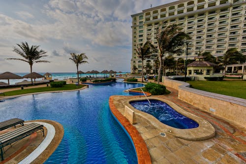 In-ground Pool Near Building during Daytime