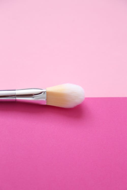 Free Silver and White Makeup Brush on Pink Surface  Stock Photo