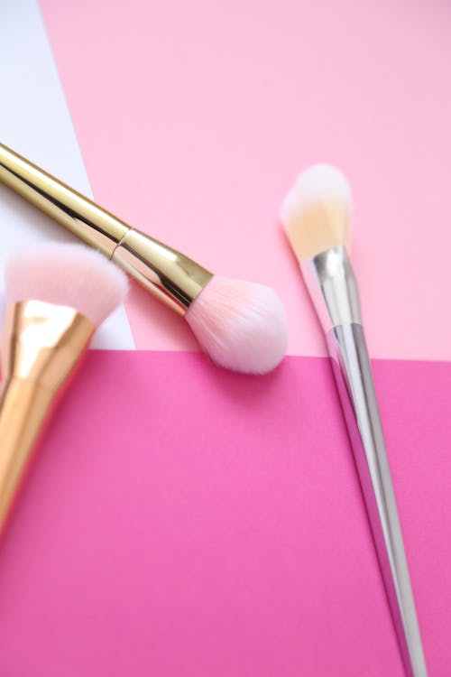 Free Makeup Brushes over a Pink Surface Stock Photo